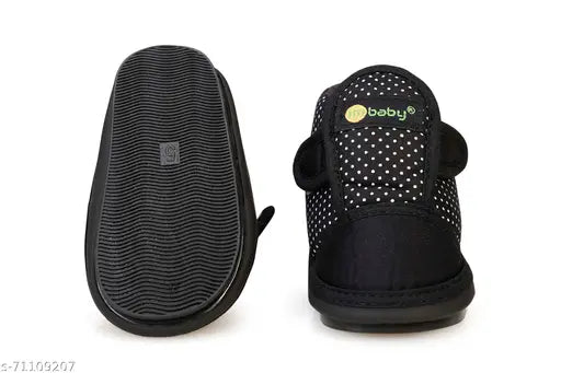 Black and white polka dot print baby shoes with a black footbed