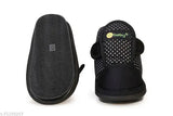 Black and white polka dot print baby shoes with a black footbed