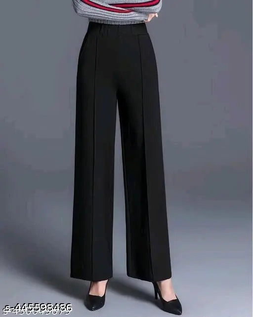 Black high-waisted flared trousers with a striped pattern at the waist