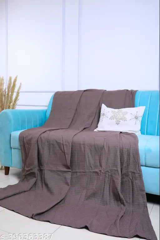 Grey cotton throw blanket, size 66 x 90 inches, covers a single bed