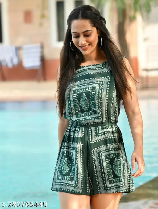Green printed A-line sleeveless casual mini jumpsuit for women, rayon fabric on hanging rack