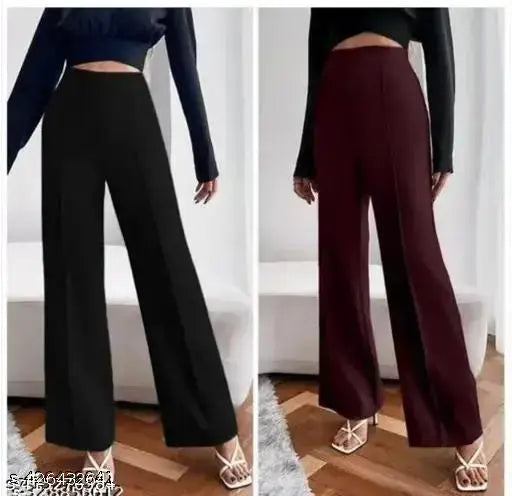 Black high-waisted jumpsuit with wide trousers, long sleeves and belted waistband