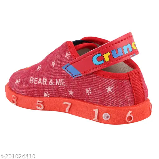 Red slip-on sneakers with black laces for kids, featuring a cartoon character on the side