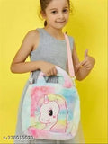 A child holding a pink and blue cartoon character handbag with a black strap