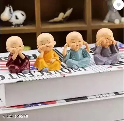 Small figurines of four monks, each with a playful expression