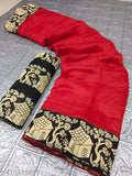 The image displays a cotton and silk saree with red and black trim, laid out on what appears to be metallic foil or paper