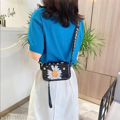 A girl wearing a blue jacket and carrying a fashionable makeup bag with a floral pattern