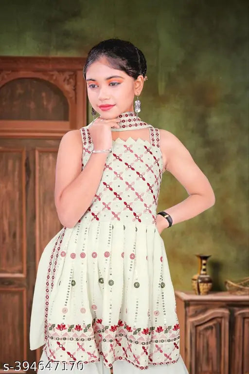 Cream 11053 maxi dress with floral print, chiffon material, woman posing by a dark wood cabinet.