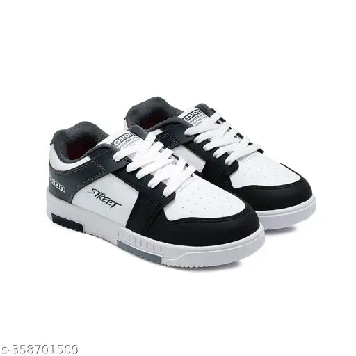 Black and white casual boys' shoe, featuring high tops with black laces and white midsoles