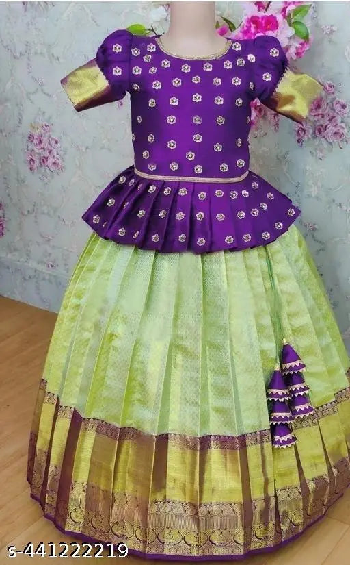 Soft silk lehenga choli with short sleeves, zari woven top and jacquard ethnic motif lehenga. Stitched net material. 2 pieces in sizes: 12-18 Months, 18-24 Months, 1-2 Years, 2-3 Years, 4-5 Years, 5-6 Years, 6-7 Years, 7-8 Years, 8-9 Years, 9-10 Years, 10-11 Years, 11-12 Years. Indian origin