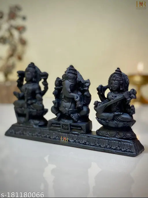 Black stone Hindu idols of Lakshmi, Ganesh and Saraswati, set on a decorative stand, home decor