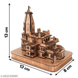 The image displays a wooden model of the Shri Ram Mandir in Ayodhya, featuring intricate detailing and carved temple with multiple levels and columns. It is set against a plain background and appears to be a 3D craft or art piece