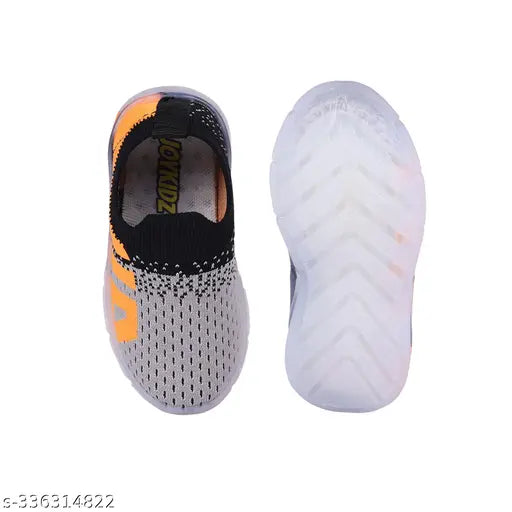 A single black and orange sports shoe with a distinctive design, featuring a white sole and upper part