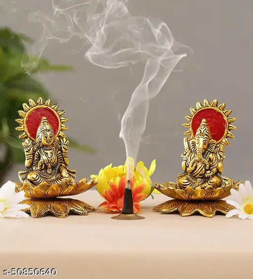 Gold metal idol statues, Lord Laxmi and Ganesh, with lotus flower base, on a showpiece for home decor