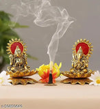 Gold metal idol statues, Lord Laxmi and Ganesh, with lotus flower base, on a showpiece for home decor