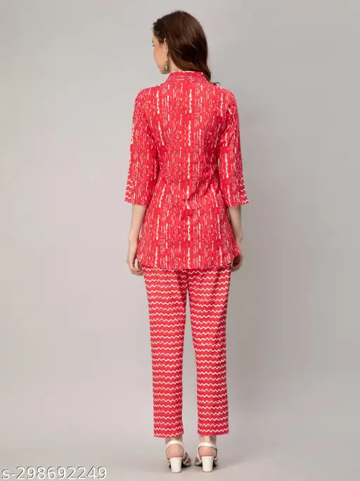 Red printed cotton co-ords set for women, features v-collar, three-quarter sleeves, slit design, button closure with belt, and comfortable 100% cotton fabric. Made in India