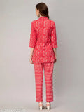 Red printed cotton co-ords set for women, features v-collar, three-quarter sleeves, slit design, button closure with belt, and comfortable 100% cotton fabric. Made in India