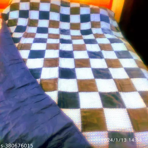 Checkered patterned quilt with blue borders