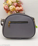 A dark grey sling bag with a zip closure, featuring a pouch on the front
