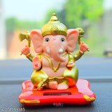 White and red solar-powered hand shaking Ganesha statue, perfect for car dashboard or office decor. Elegant design, unique finish, and lightweight. Ideal spiritual lucky gift, suitable for business success and good fortune. Made in India
