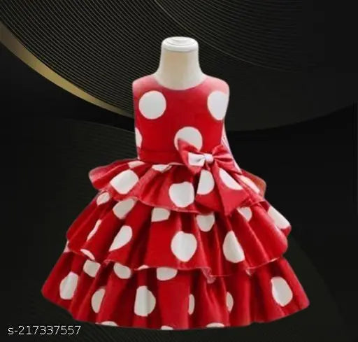 Red and white polka dot dress with ruffled hem, girls' party wear, long-sleeved design, likely for a special occasion or event