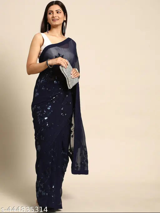 A woman in a blue sequined saree with floral designs