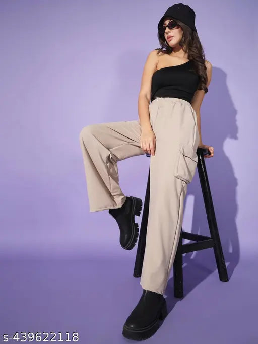Woman wearing high-waisted beige cargo pants, black boots and a black cap