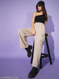 Woman wearing high-waisted beige cargo pants, black boots and a black cap