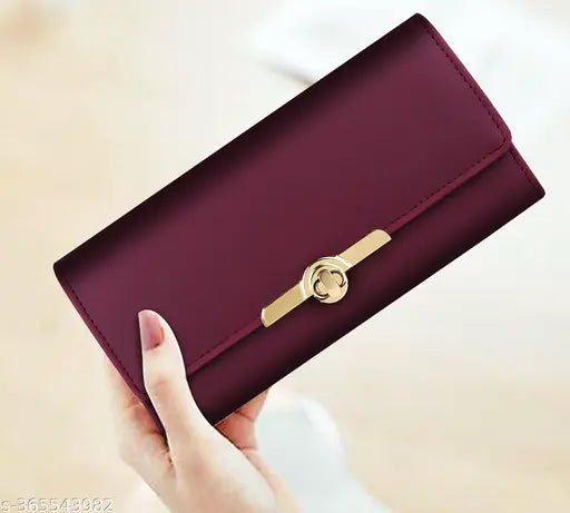 A red clutch with a twist lock, designed for women, holding four cards