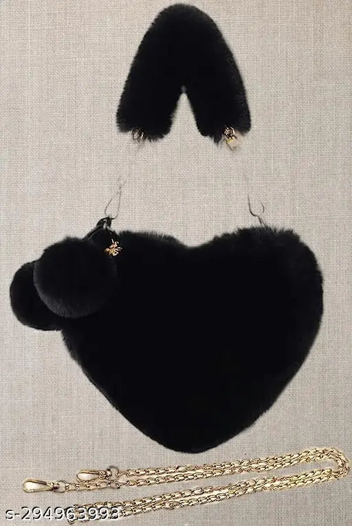Black faux fur heart-shaped shoulder bag with zipper closure and pom pom accents
