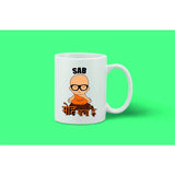 Coffee mug with white ceramic surface, black print of a cartoon-style face, and a phrase in an Indian language