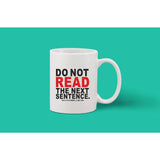 White ceramic coffee mug with quote, "Do not read the next sentence