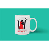 A single piece white ceramic coffee mug with a printed graphic and a person's face, reading 'Hit Wicket!