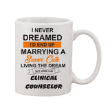 The coffee mug is white, printed with black text featuring a humorous quote about marriage. It contains the phrase "I'D END UP DREAMING ABOUT MARRYING A SUPER CUTE DOG LIVING THE DREAM BUT I'M HERE FOR YOU CLINICAL COUNSELOR," and it has 11oz of liquid in it
