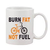 White ceramic coffee mug with printed design featuring bicycle and text saying 'Burn Fat Not Fuel' - One piece, 11 oz